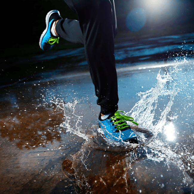 Guy running in water with waterproof shoes