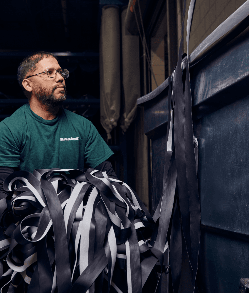 Haartz Employee carrying waste product to bin
