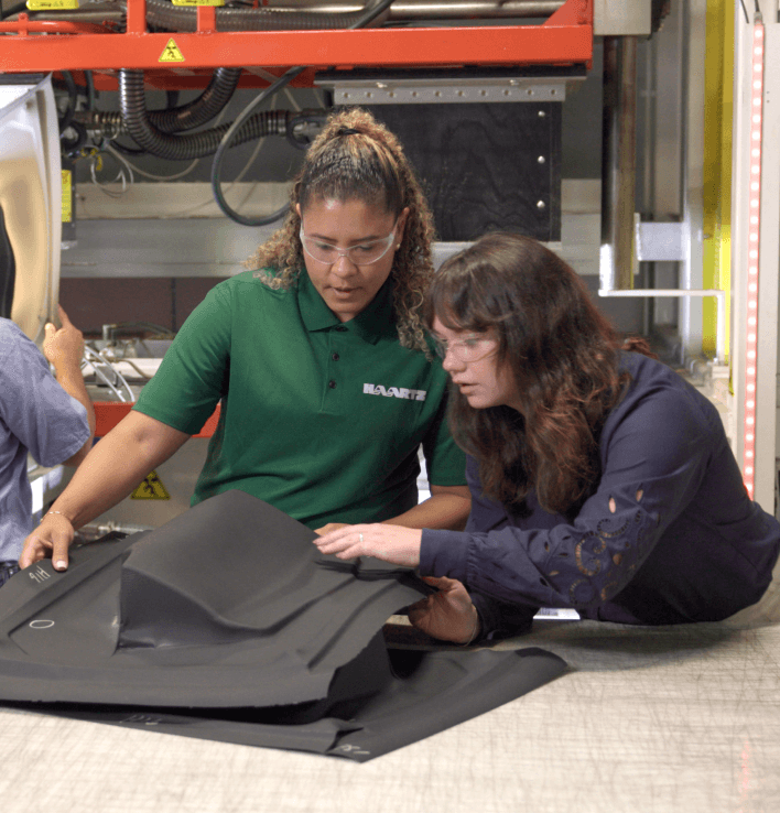 Haartz employees looking at product