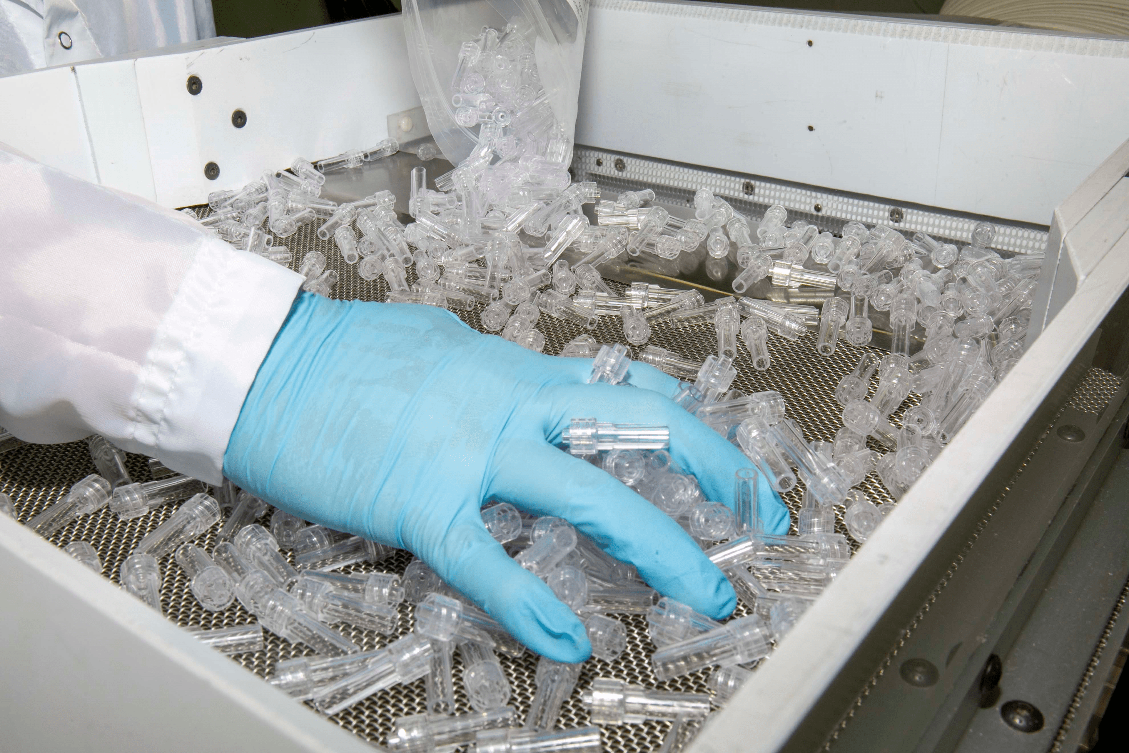 scientist with gloves spreading plastic caps
